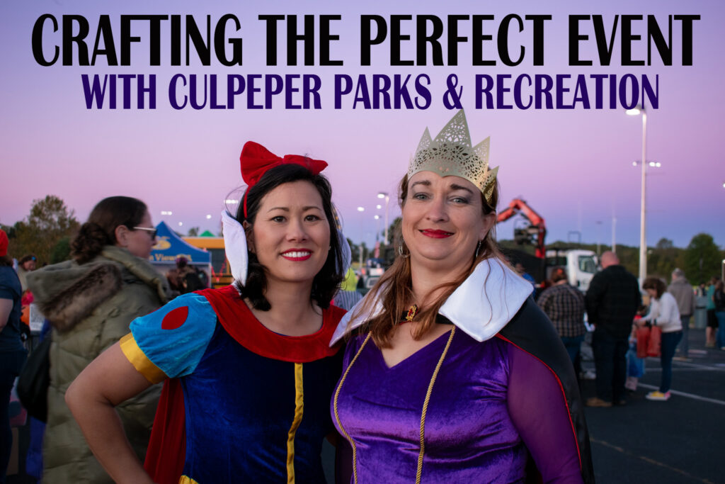 Two women dressed up in costumes posing together with the words, "CRAFTING THE PERFECT EVENT WITH CULPEPER PARKS & RECREATION" above their heads. 